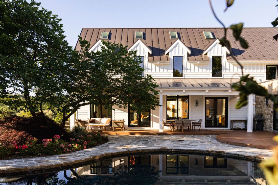 poolside-covered-porch-stone-deck-farmhouse-luxury-1100x733.jpg