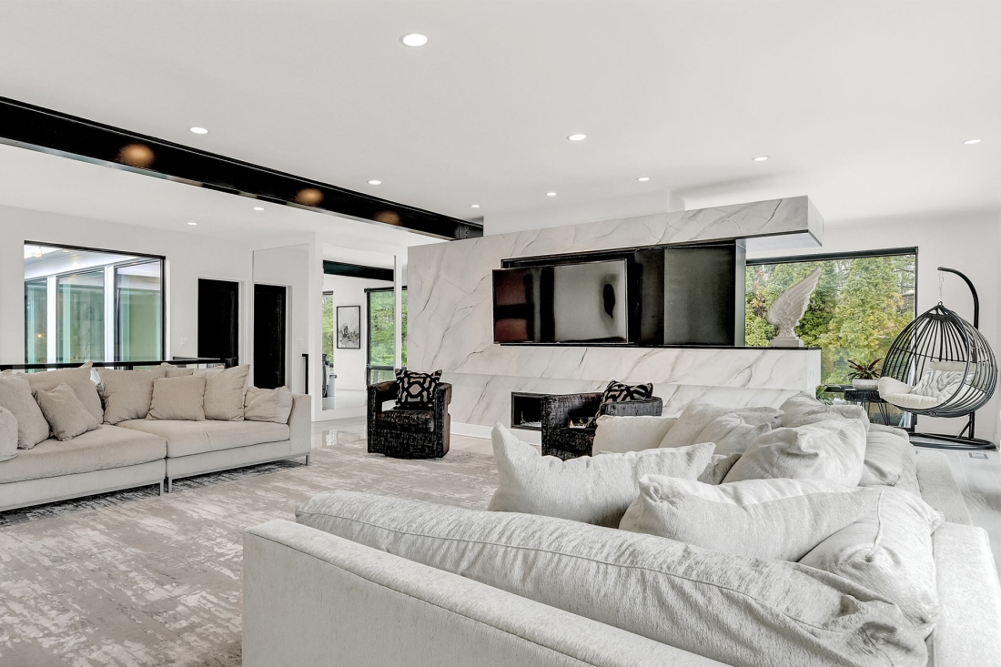 midcentury-modern-renovation-post-modern-remodel-large-living-room-white-sofas-fireside-chairs-modern-focal-TV-wall-NorthernMaryland-1100x733.jpg